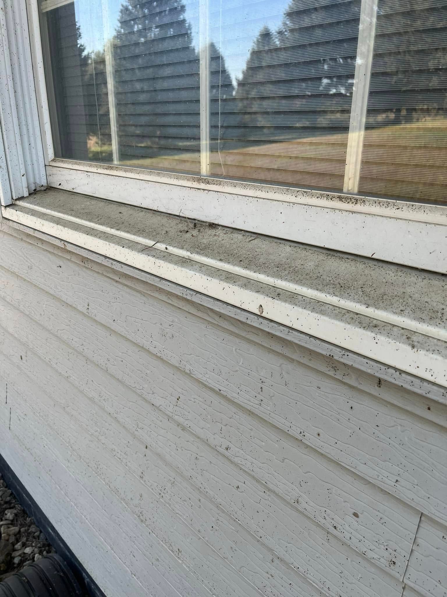 A close up of a window sill on a house.