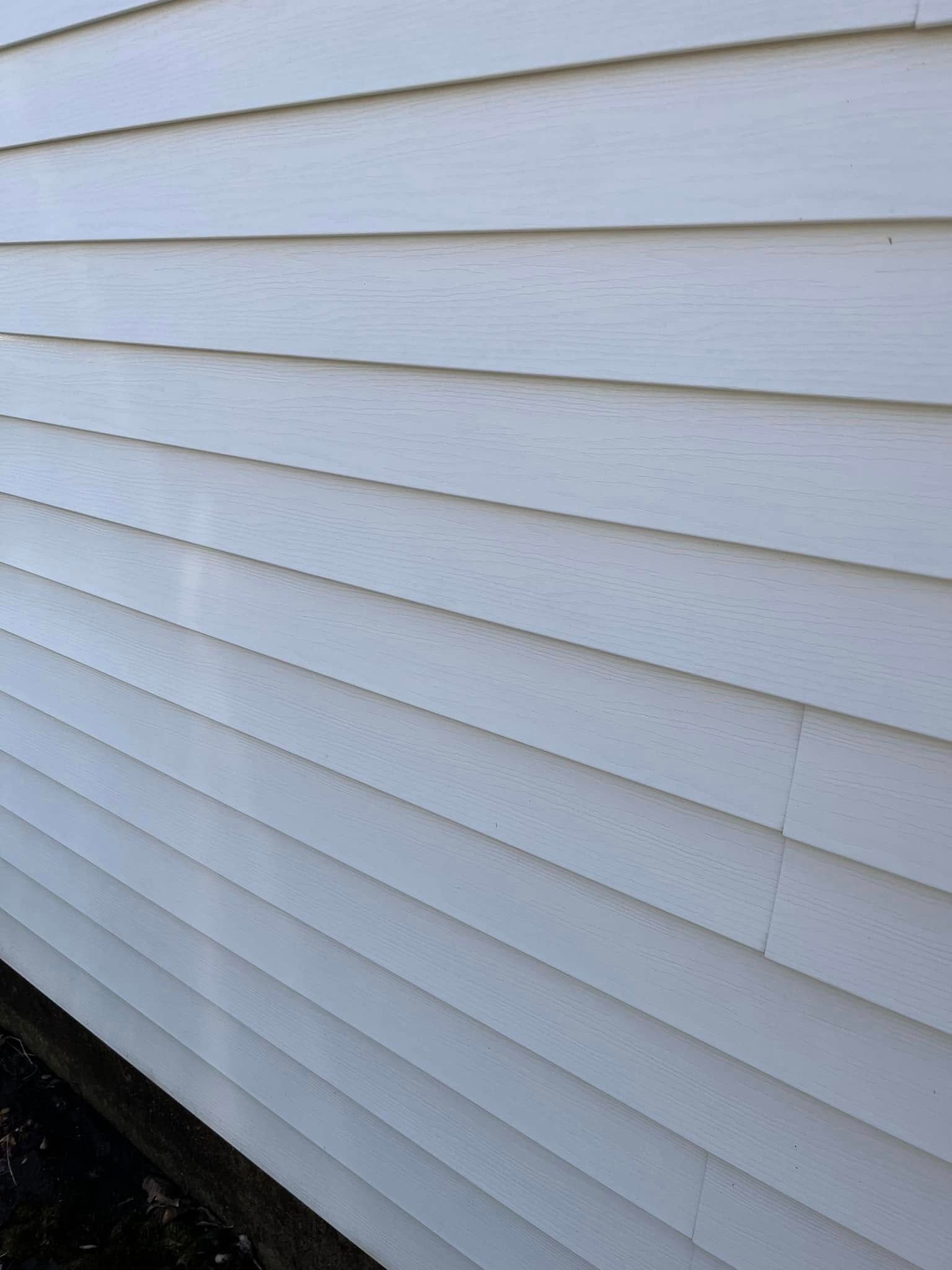 A close up of a white siding on a house