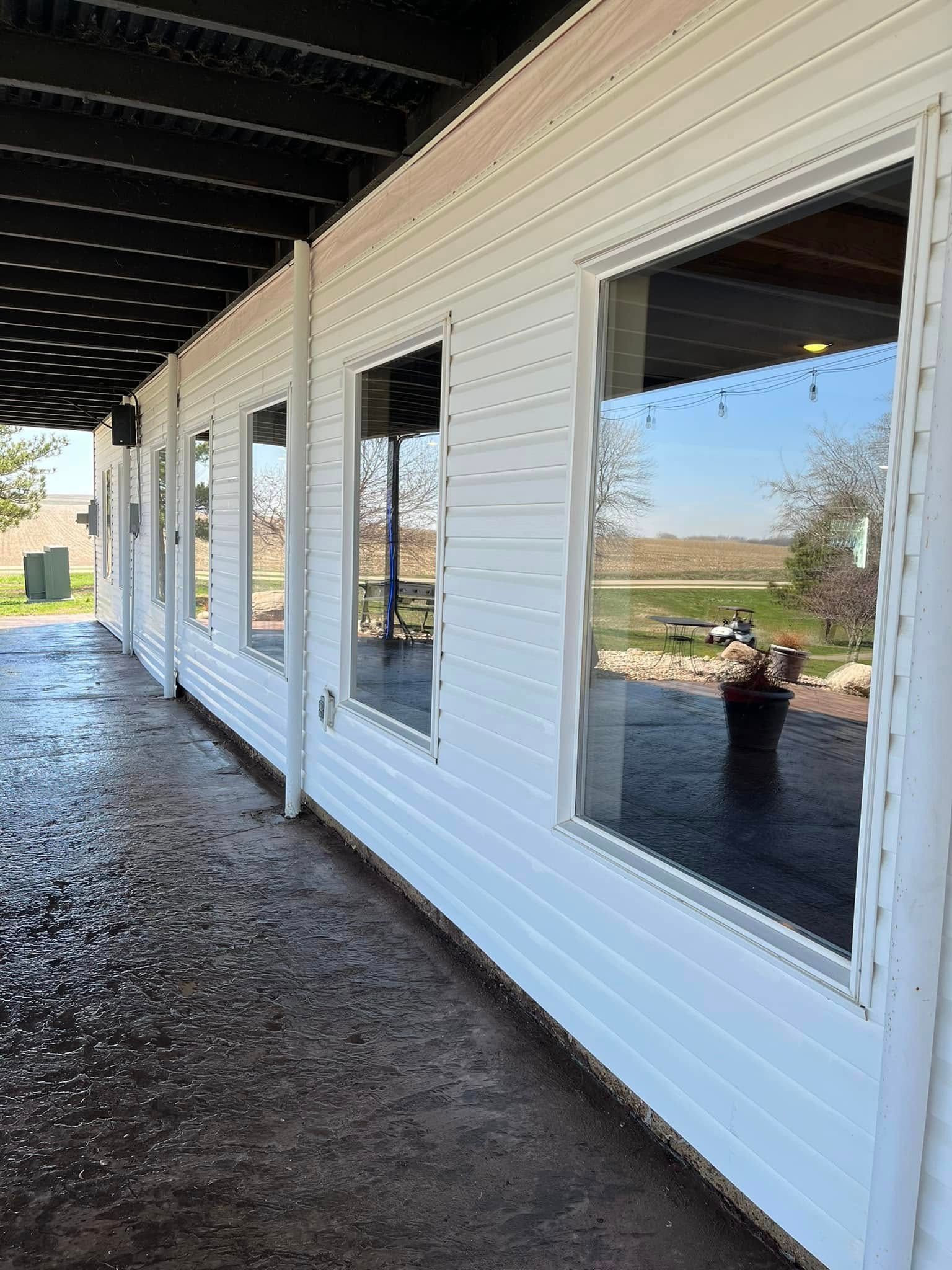 A long white building with a lot of windows and a covered walkway.