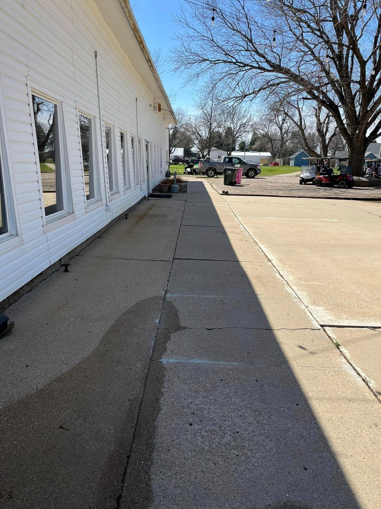 A white building with a lot of windows is being remodeled.