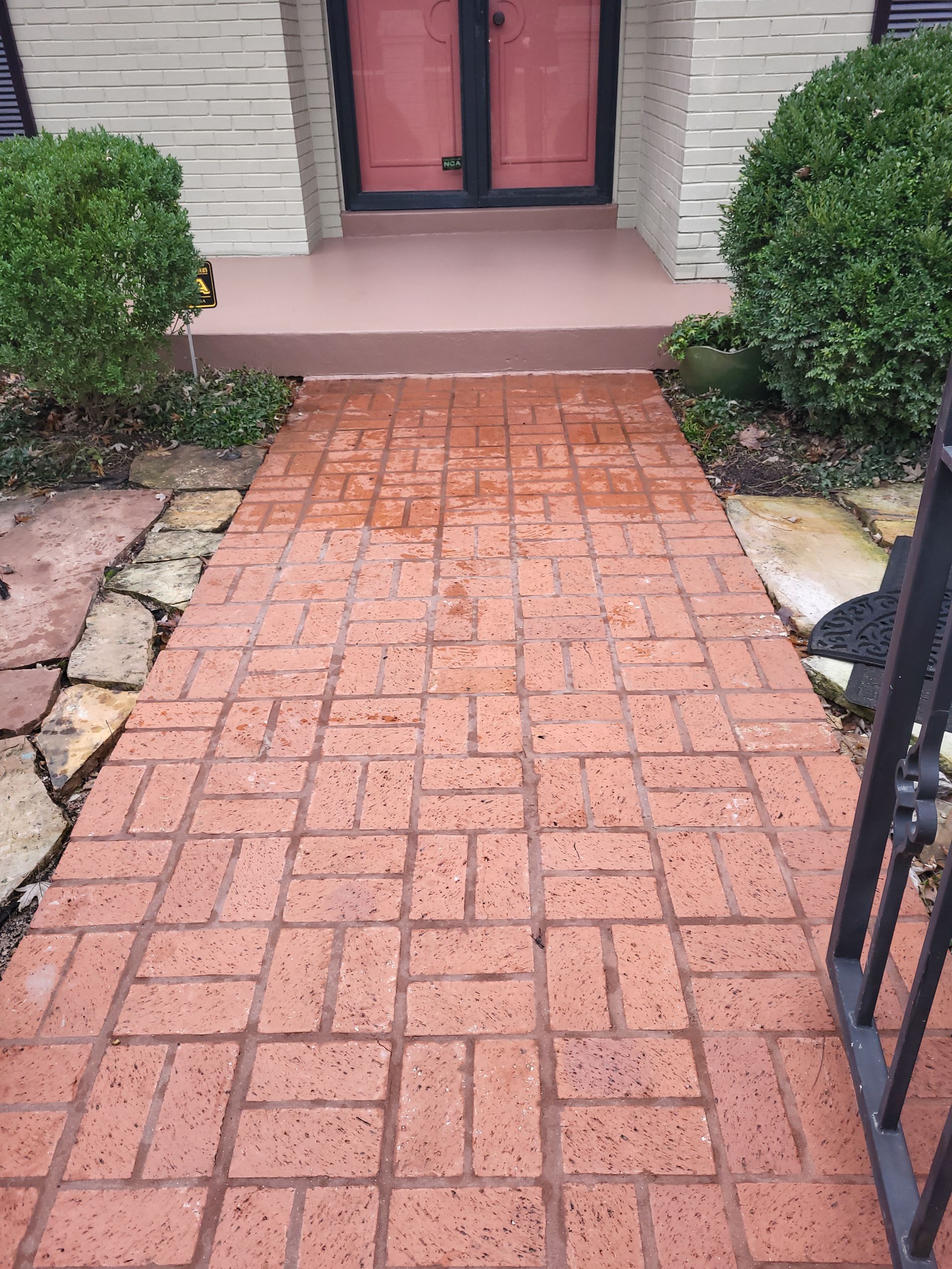 A brick walkway leading to the front door of a house