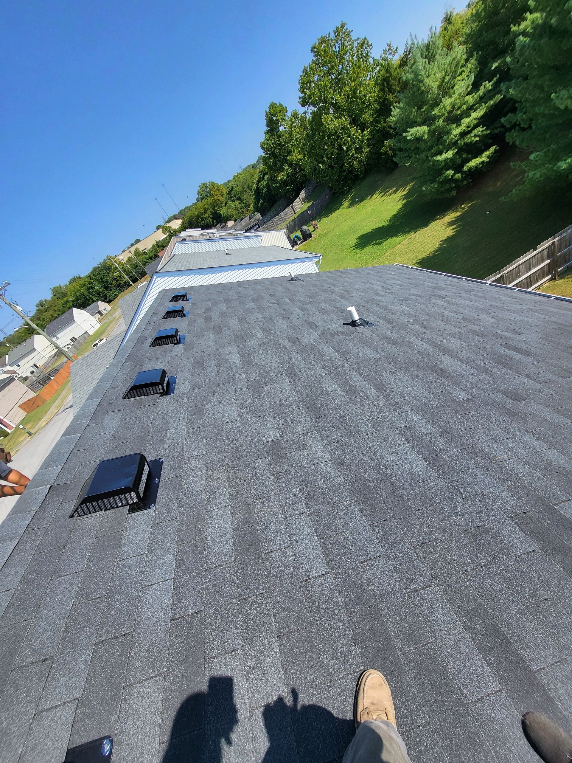A person is standing on the roof of a building.