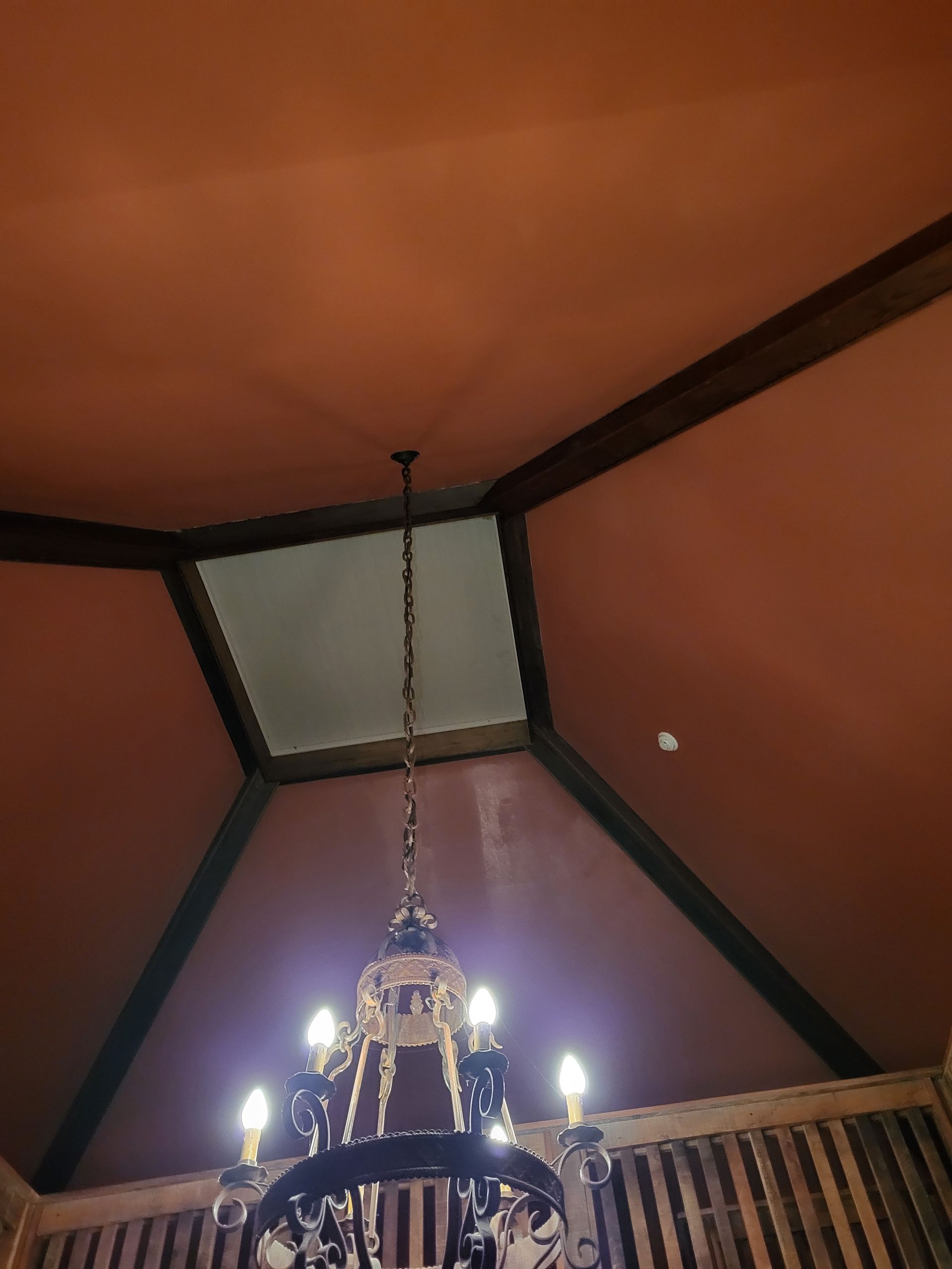 A chandelier is hanging from the ceiling of a room