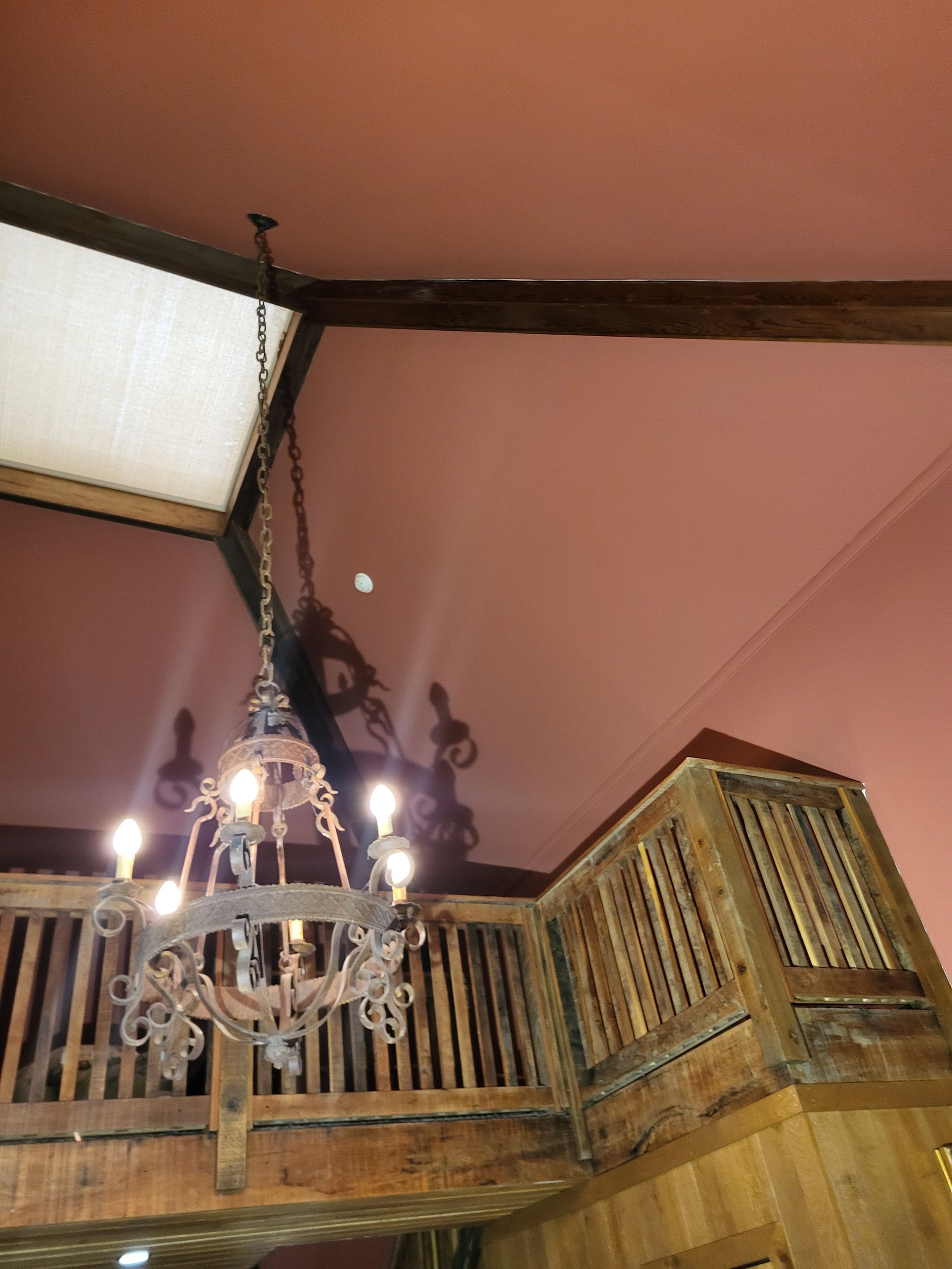 A chandelier is hanging from the ceiling of a room