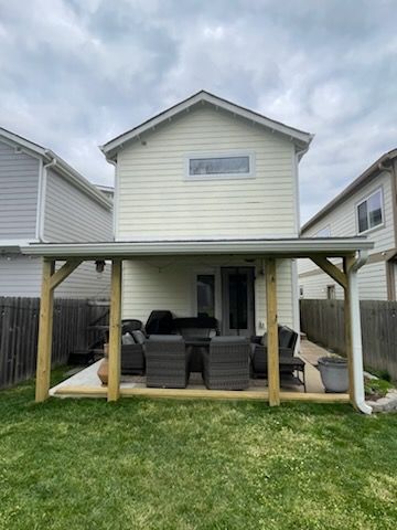 A house with a covered patio in the backyard.