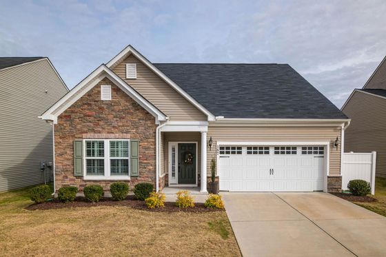 A brick walkway leading to the front door of a house.