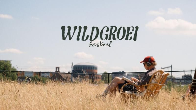 Een persoon met een koptelefoon op zit in een rieten stoel te lezen in een veld met droog gras, met daarop festivaltekst.