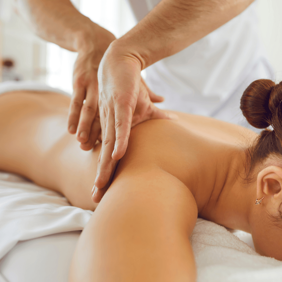 A woman is getting a massage on her back at a spa.