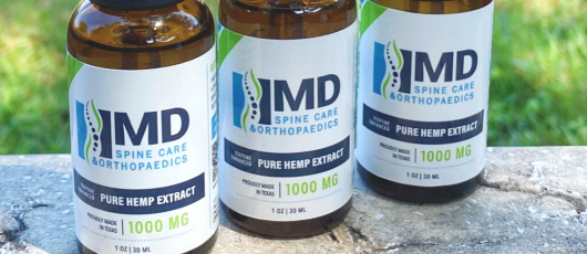 Three bottles of md hemp extract are sitting on a table.