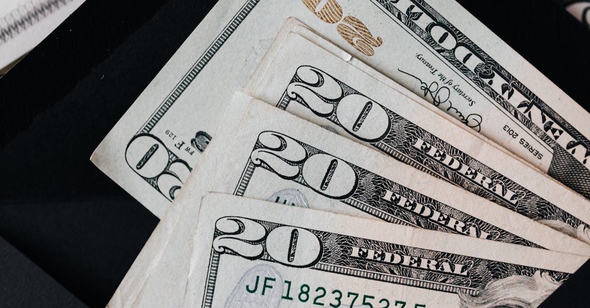 A bunch of 20 dollar bills are stacked on top of each other