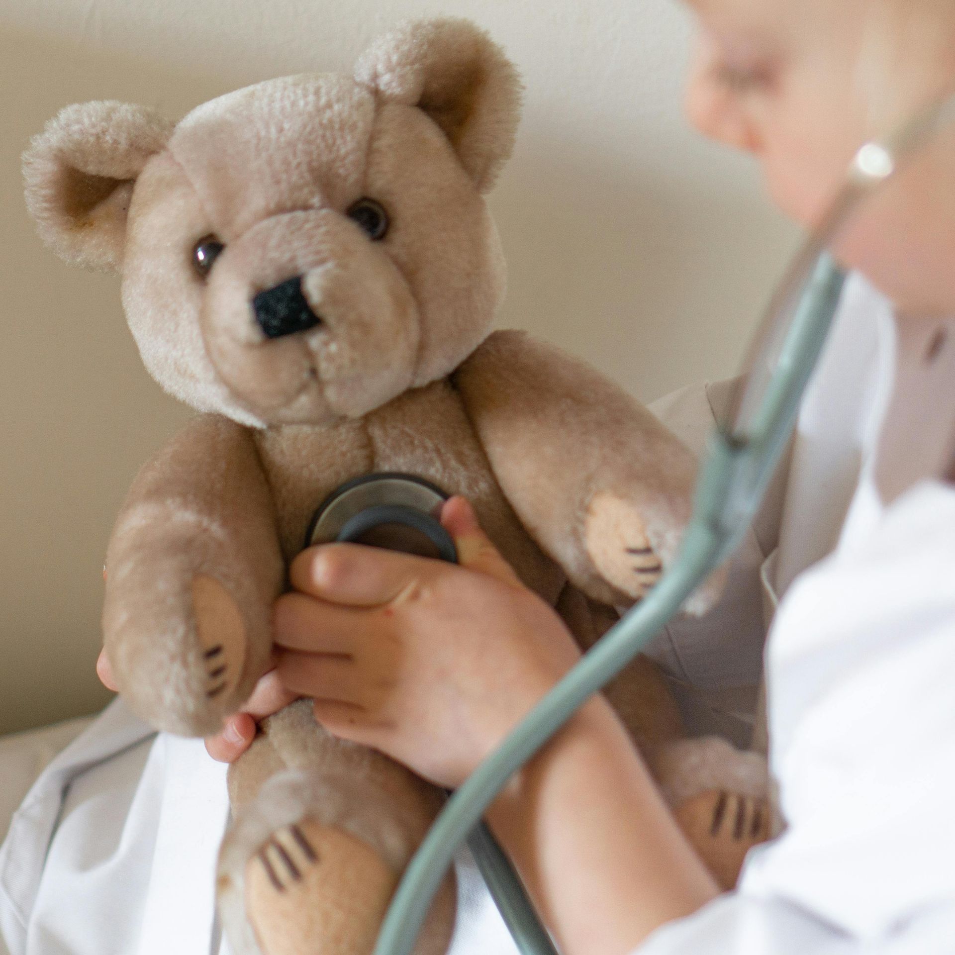 kid listening to teddy bear's heart