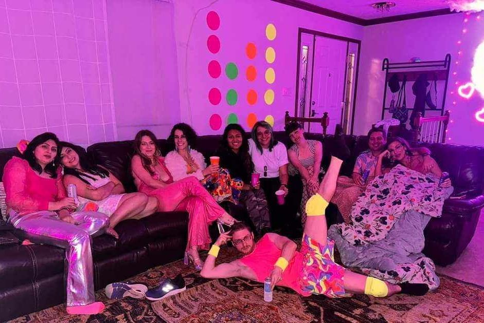 A group of women are sitting on a couch in a living room.