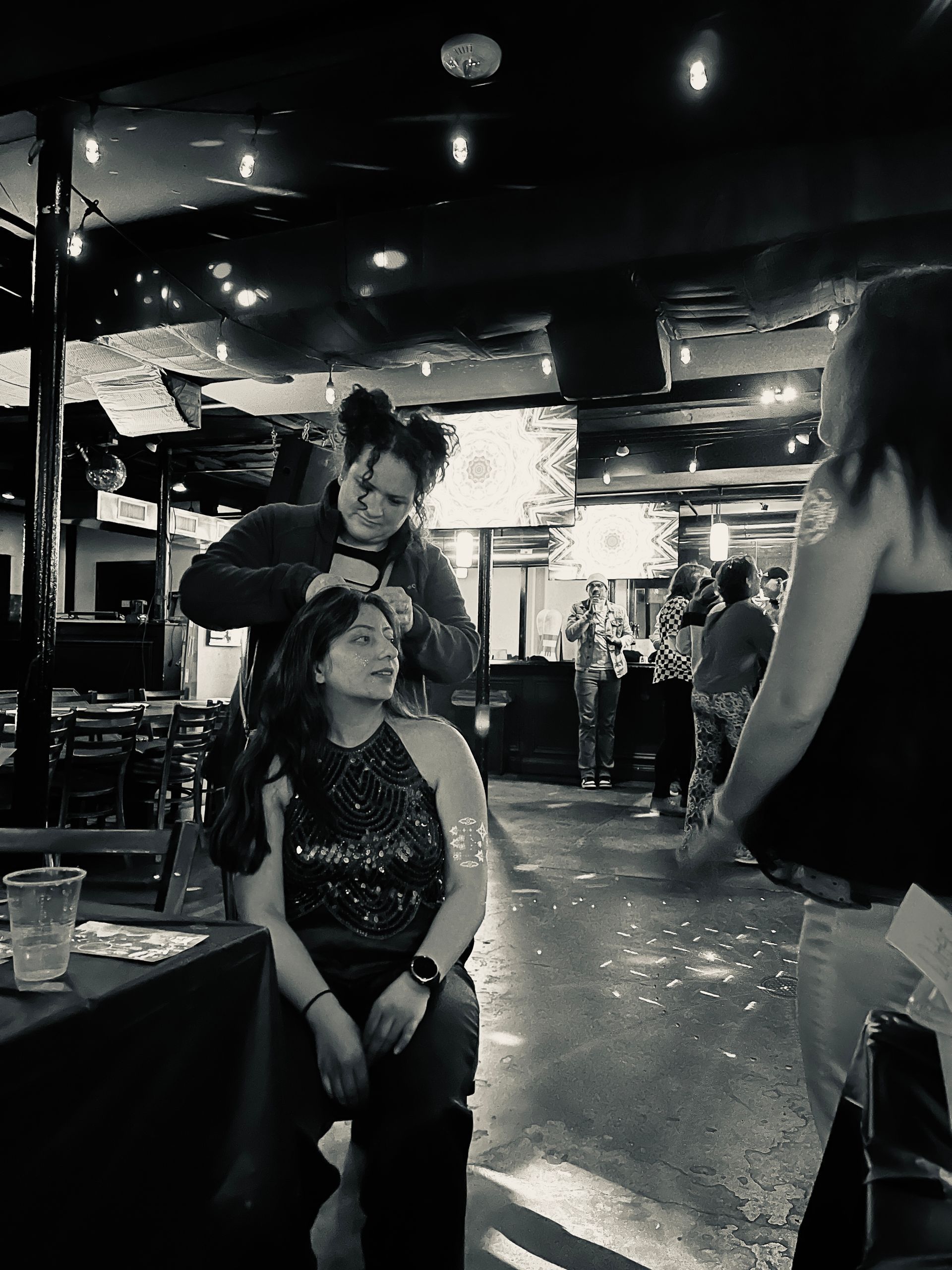 Scarlett hair is doing DJ Begum's hair done in a black and white photo