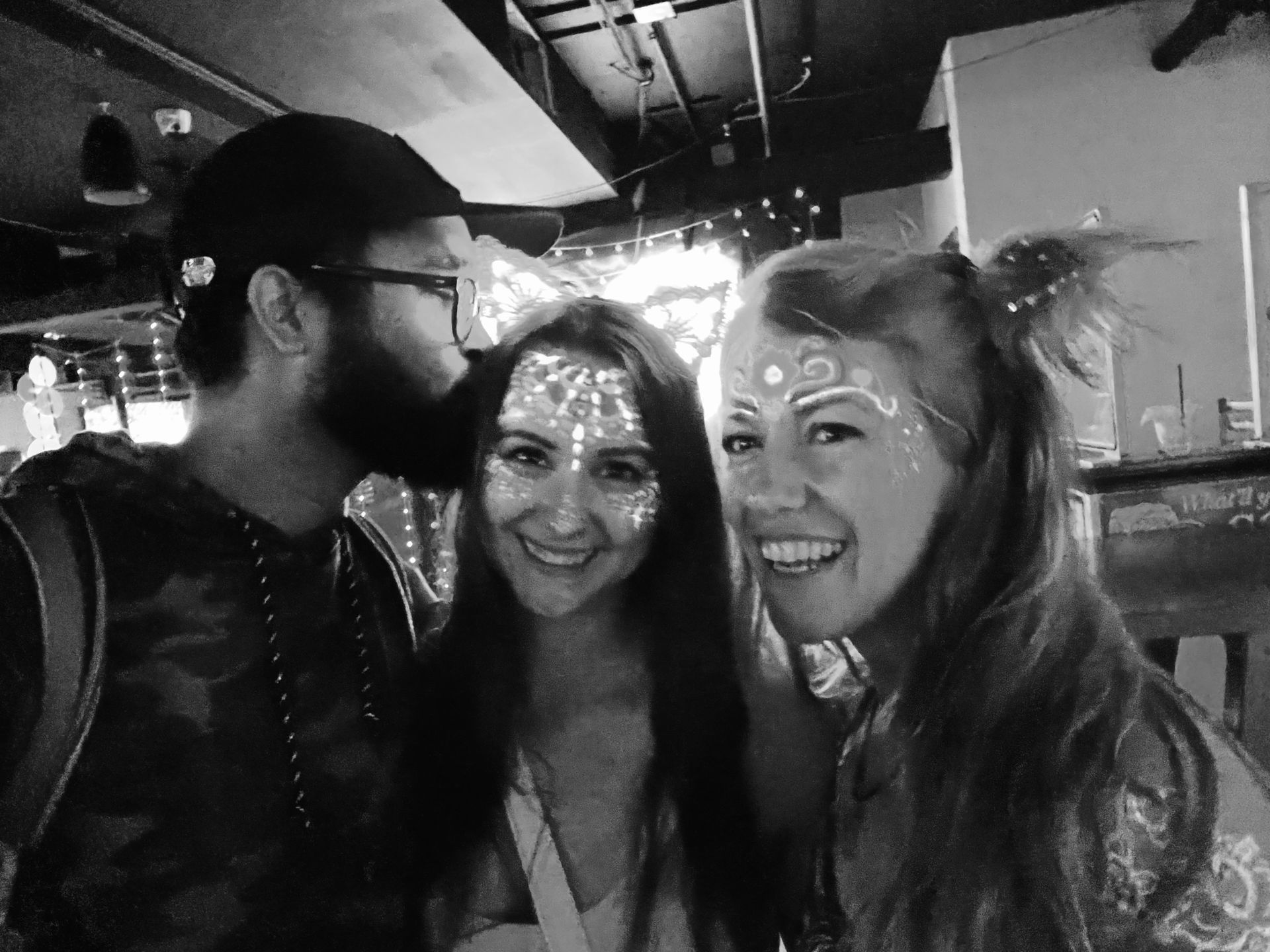 A couple and their friend are posing for a black and white photo