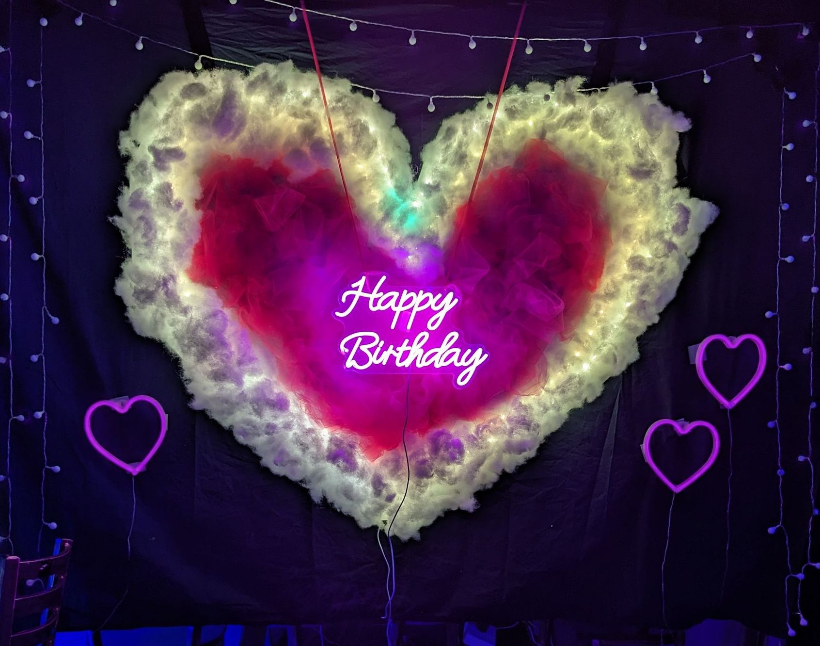 A heart made of cotton candy with the words `` happy birthday '' written on it.