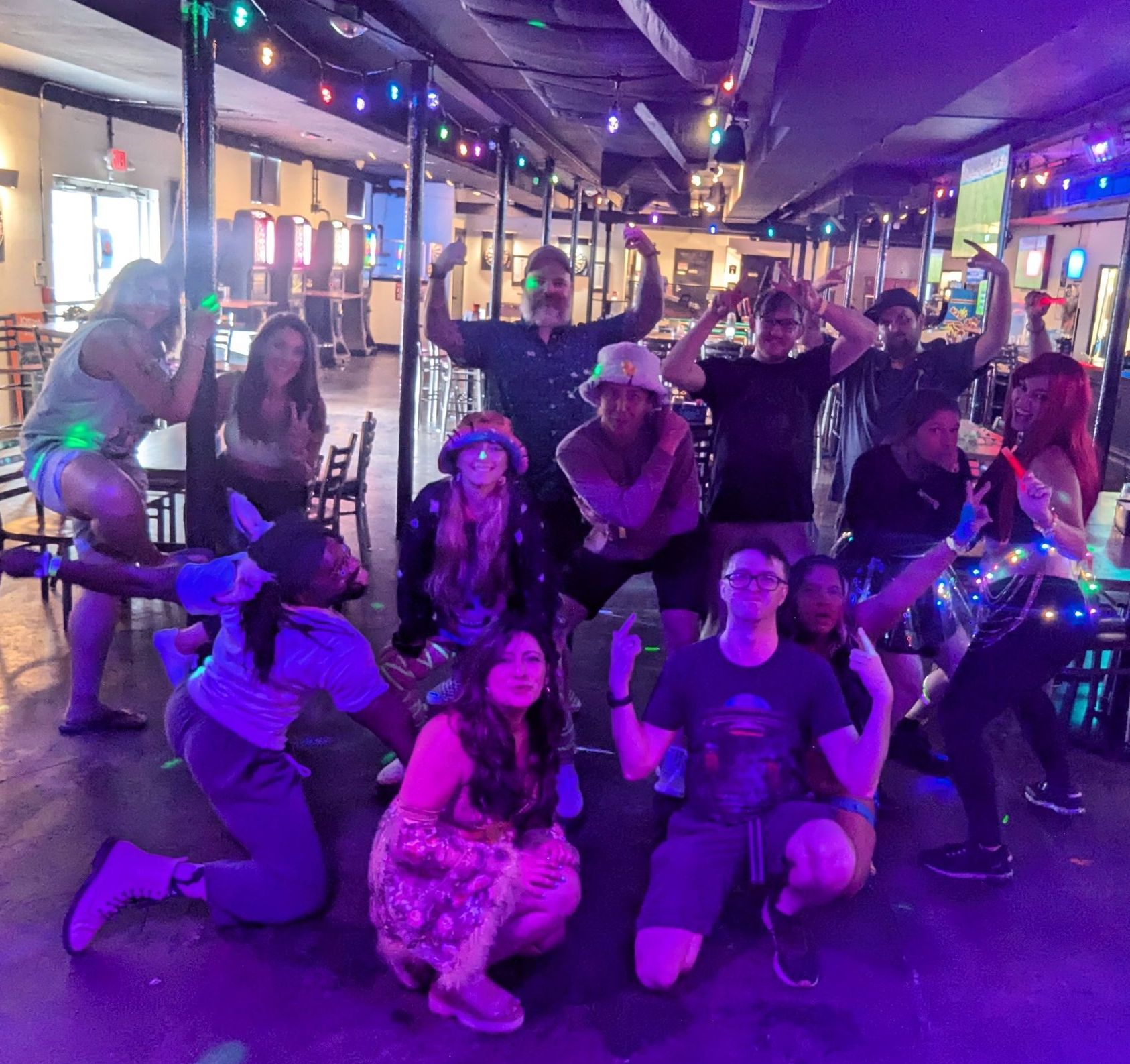 A group of friends are posing for a picture in a restaurant.