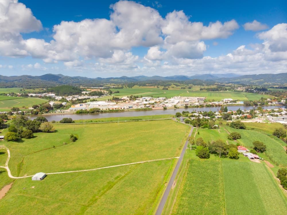 An Aerial View of A Lush Green Field with A River in The Background — Twin Lakes Towing & Recovery in Cardiff, NSW