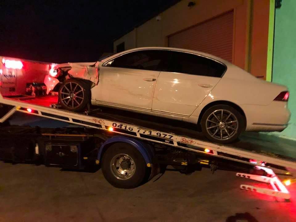 A White Car Is Sitting on Top of A Tow Truck — Twin Lakes Towing & Recovery in Beresfield, NSW