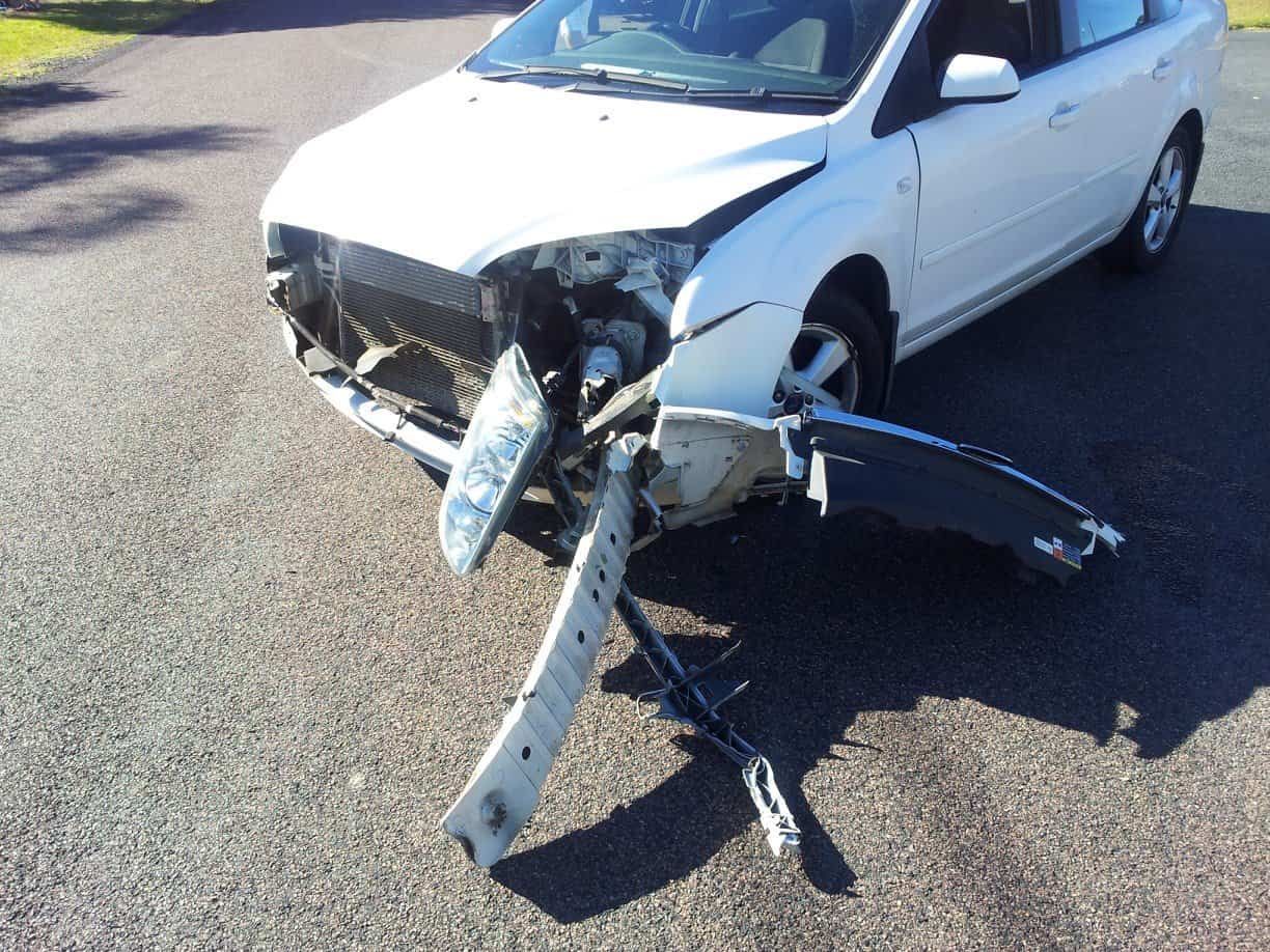 A White Car that Has Been Damaged in An Accident — Twin Lakes Towing & Recovery in Hexham, NSW