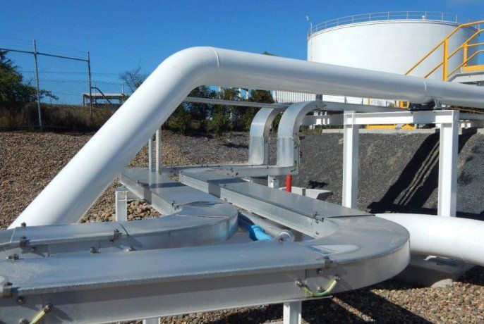 Outdoor White Tanks with Large Tubes — Electricians in Mackay, QLD
