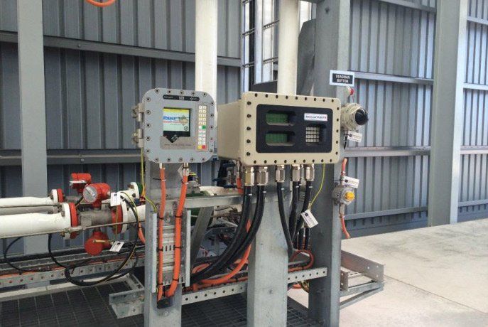 An Electrical Machine Connected with Orange Wires — Electricians in Mackay, QLD