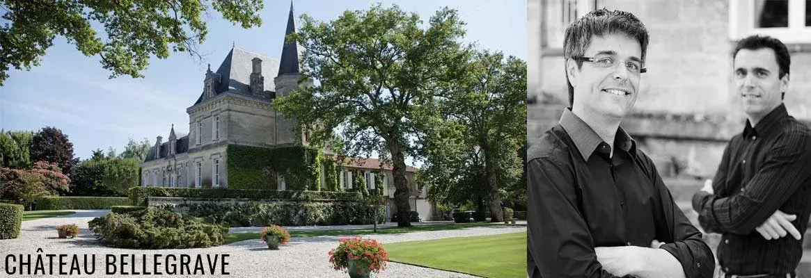 Chateau Bellegrave with two men in front. Large building, green yard, and a clear day.