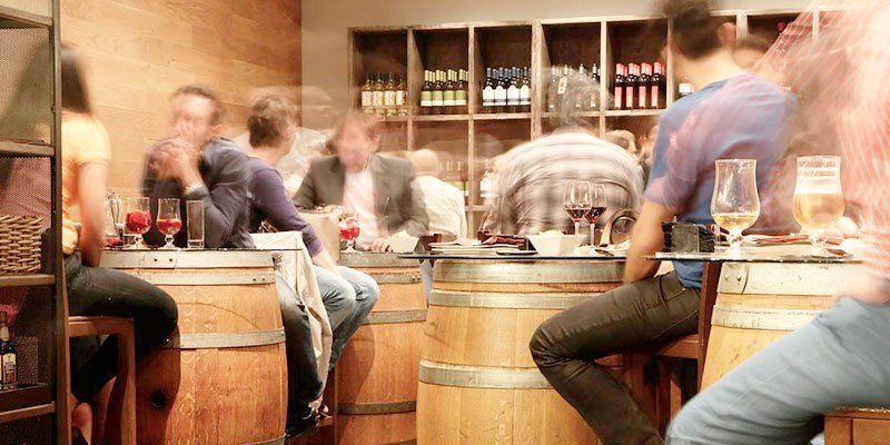 People drinking wine in a wine bar or tasting room