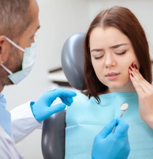 Emergency Dentistry | Woman holding mouth in pain | same day emergency dentist near Garland TX 75040
