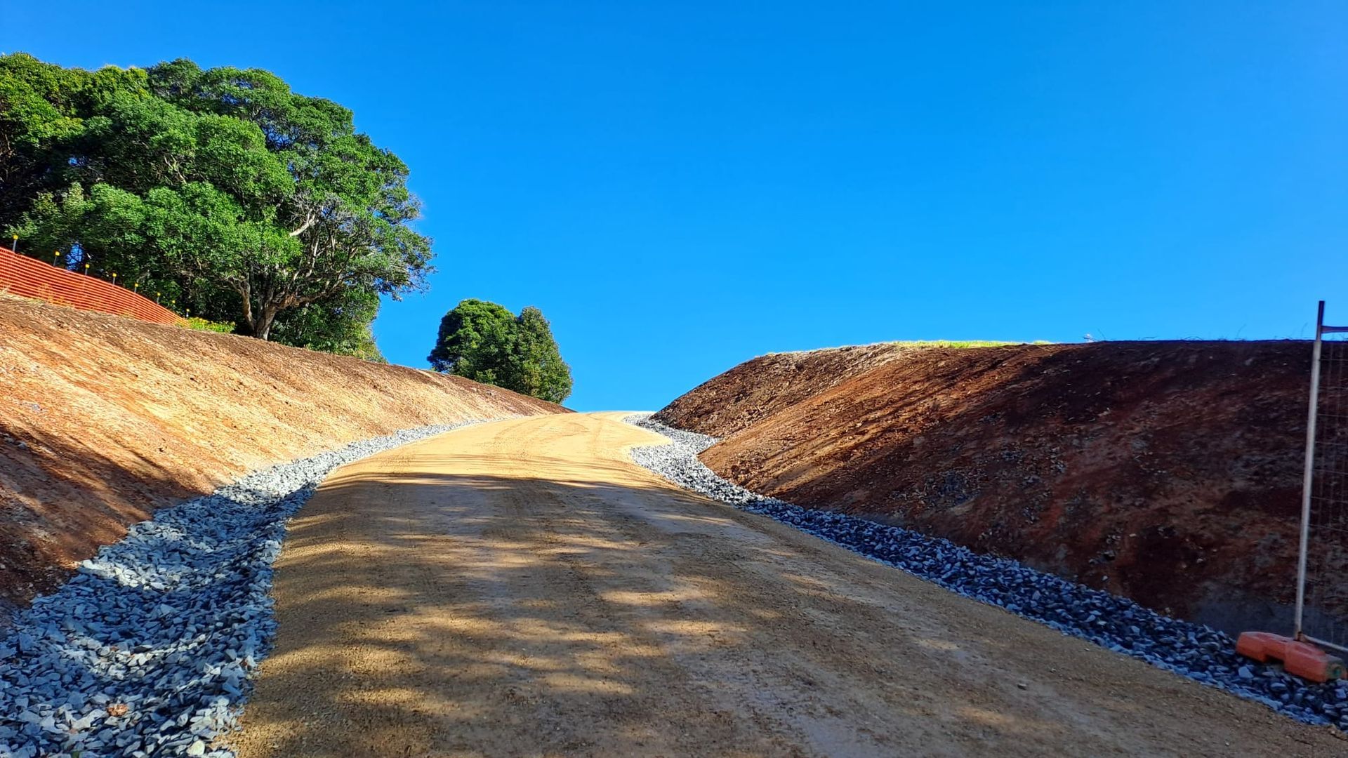 A Group Of Men Are Working On A Patch Of Asphalt In A Parking Lot — East Point Earthmoving in Brunswick Head, NSW