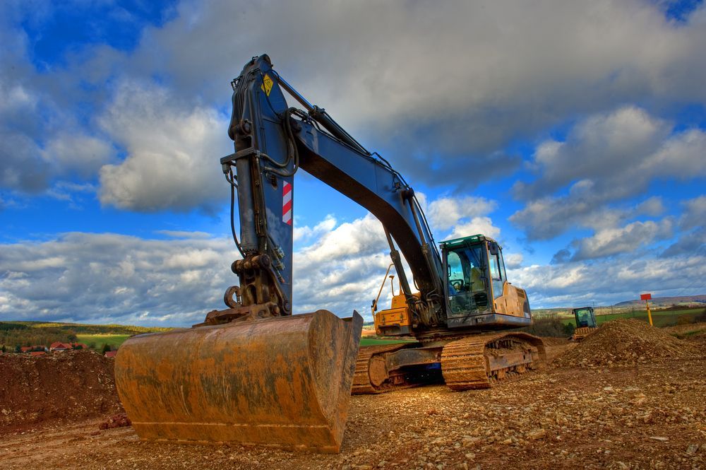 Excavator on a Construction Site Under a Blue — East Point Earthmoving in Brunswick Heads, NSW