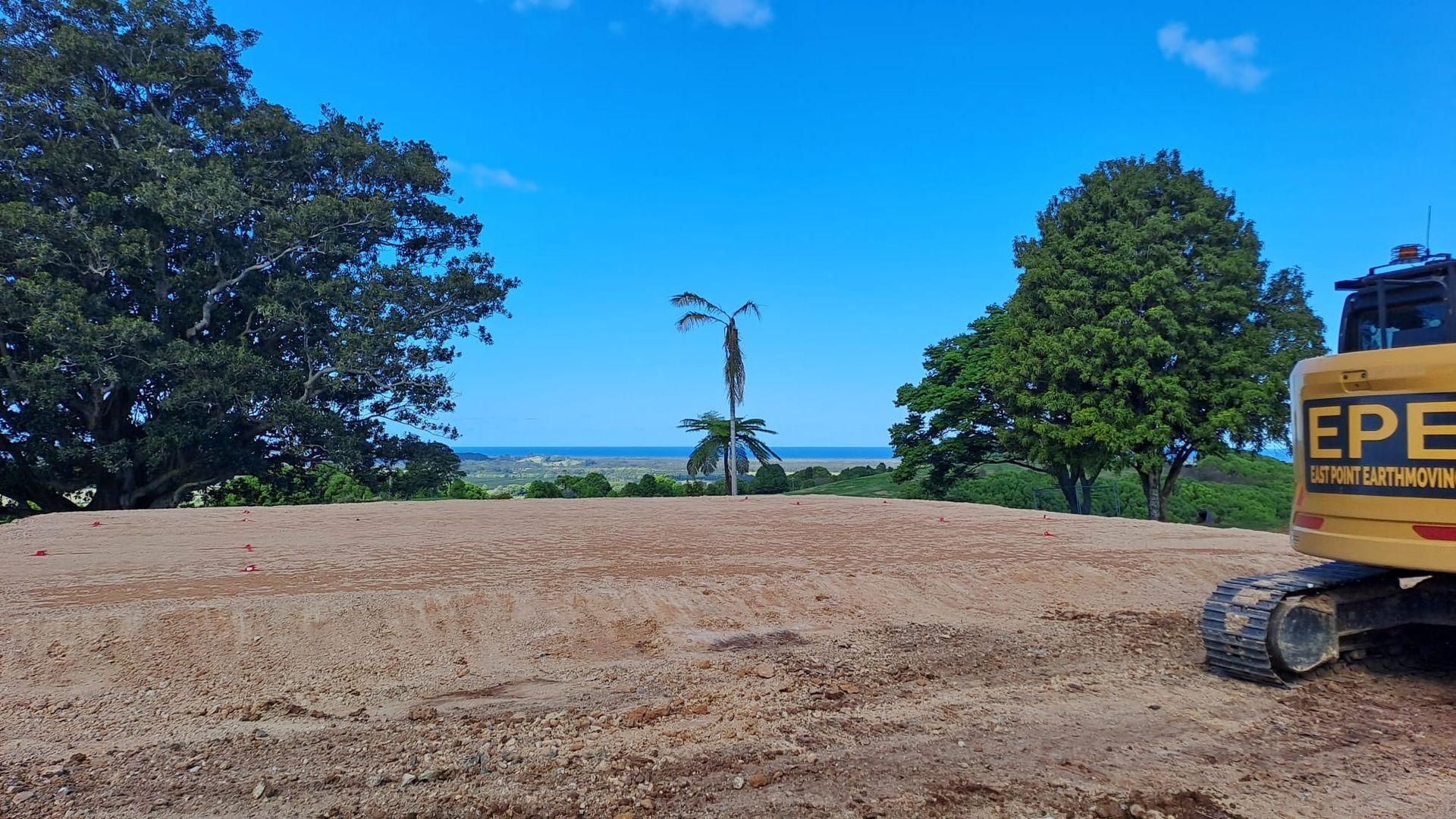 A Dirt Field Over Looking The Water— East Point Earthmoving in Byron Bay, NSW