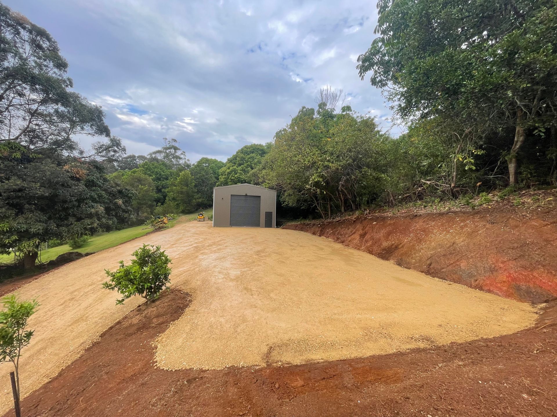 A Bulldozer Is Loading Mulch Into A Pile Of Mulch — East Point Earthmoving in Byron Bay, NSW