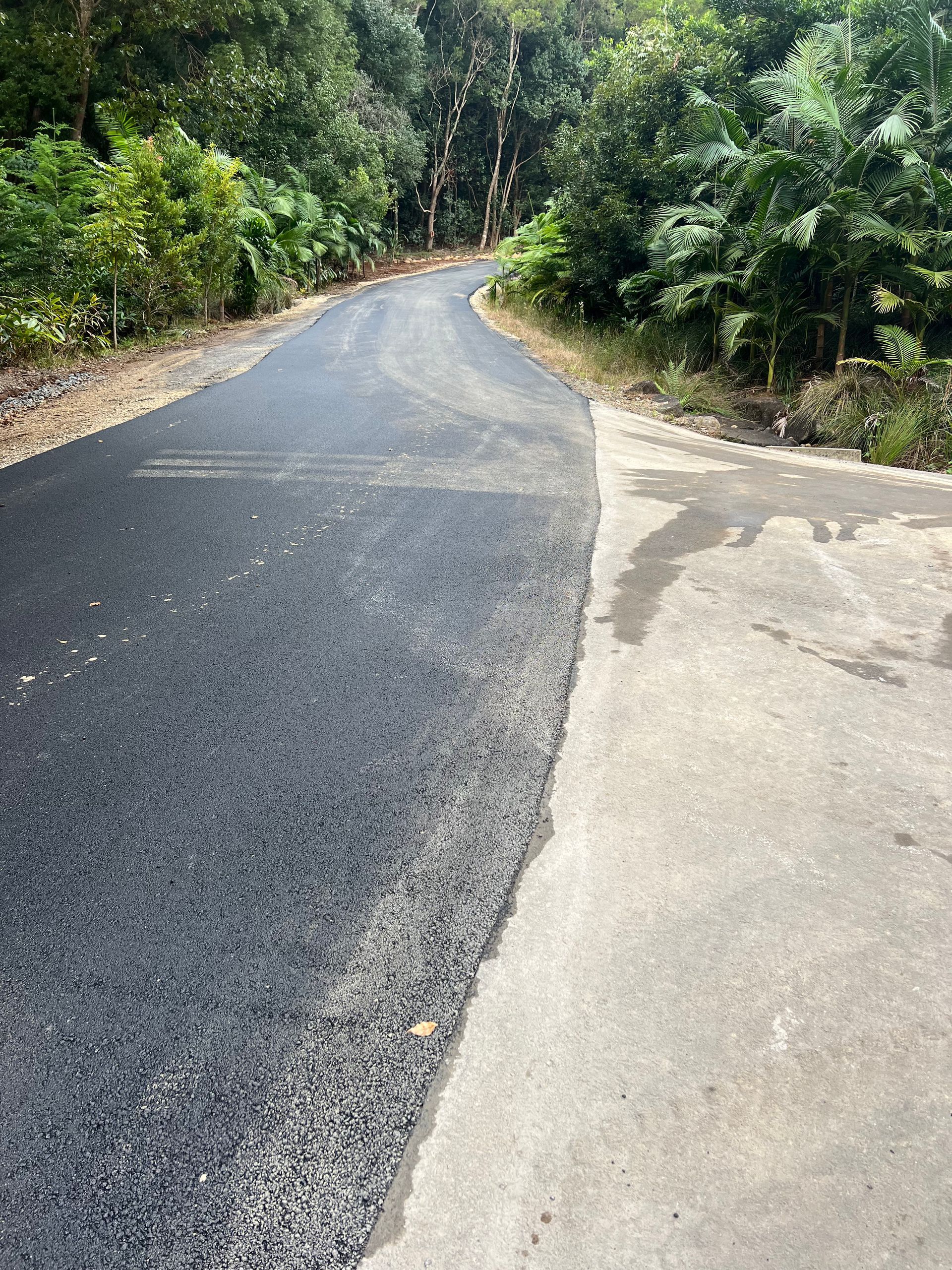A Bulldozer Is Moving Dirt On A Muddy Road — East Point Earthmoving in Byron Bay, NSW