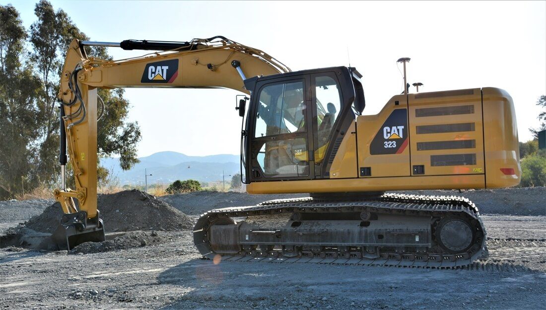 A Yellow Cat Excavator Is Parked In A Gravel Area — East Point Earthmoving in Lennox Head, NSW
