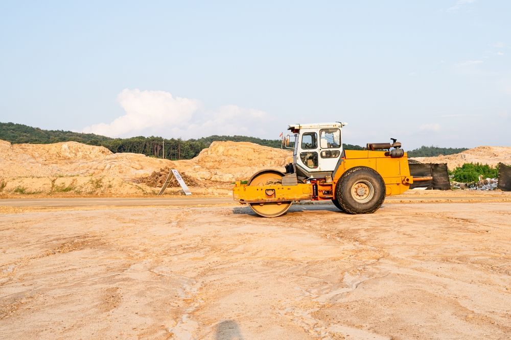 Yellow Road Roller on a Sandy Construction Site — East Point Earthmoving in Ballina, NSW
