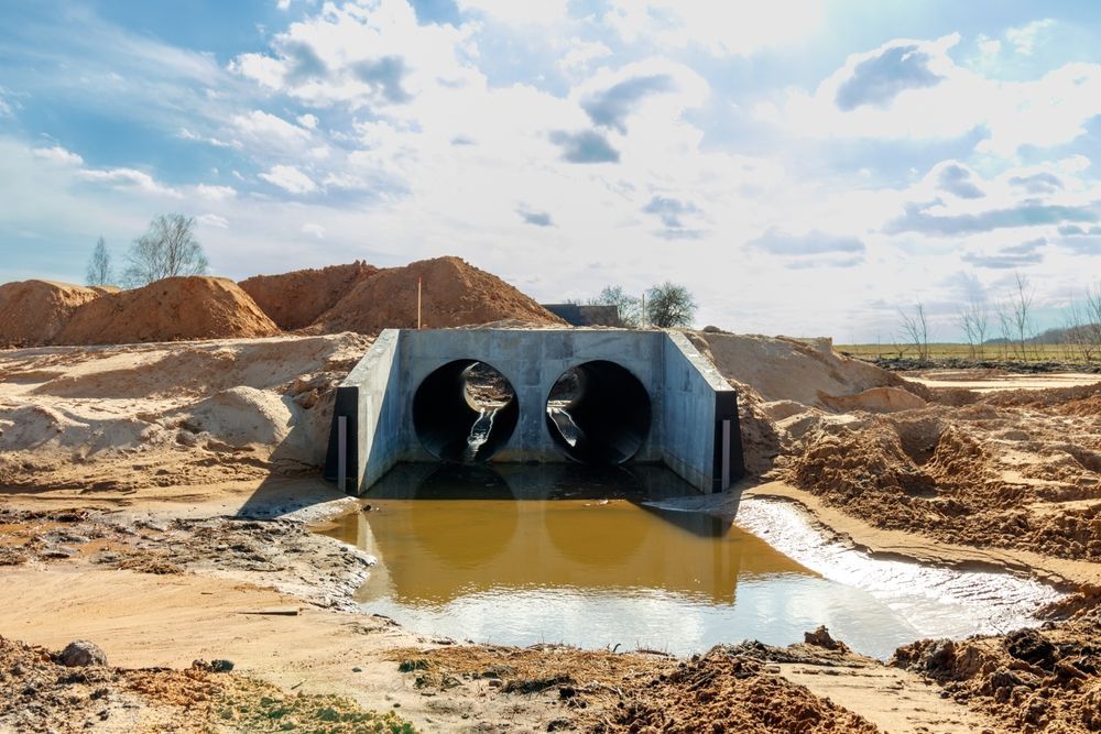 Concrete Culvert With Two Circular Openings in a Muddy — East Point Earthmoving in Mullumbimby, NSW
