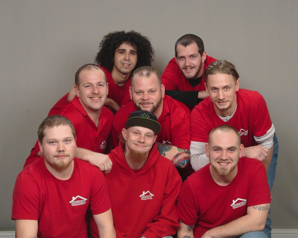 Team Members In Red Shirts — Warren, OH — Brothers Roofing & Siding