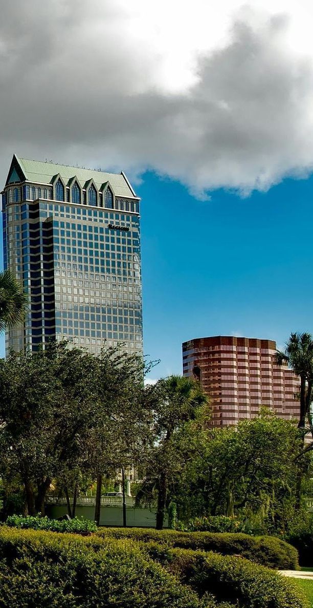 A tall building with palm trees in front of it.