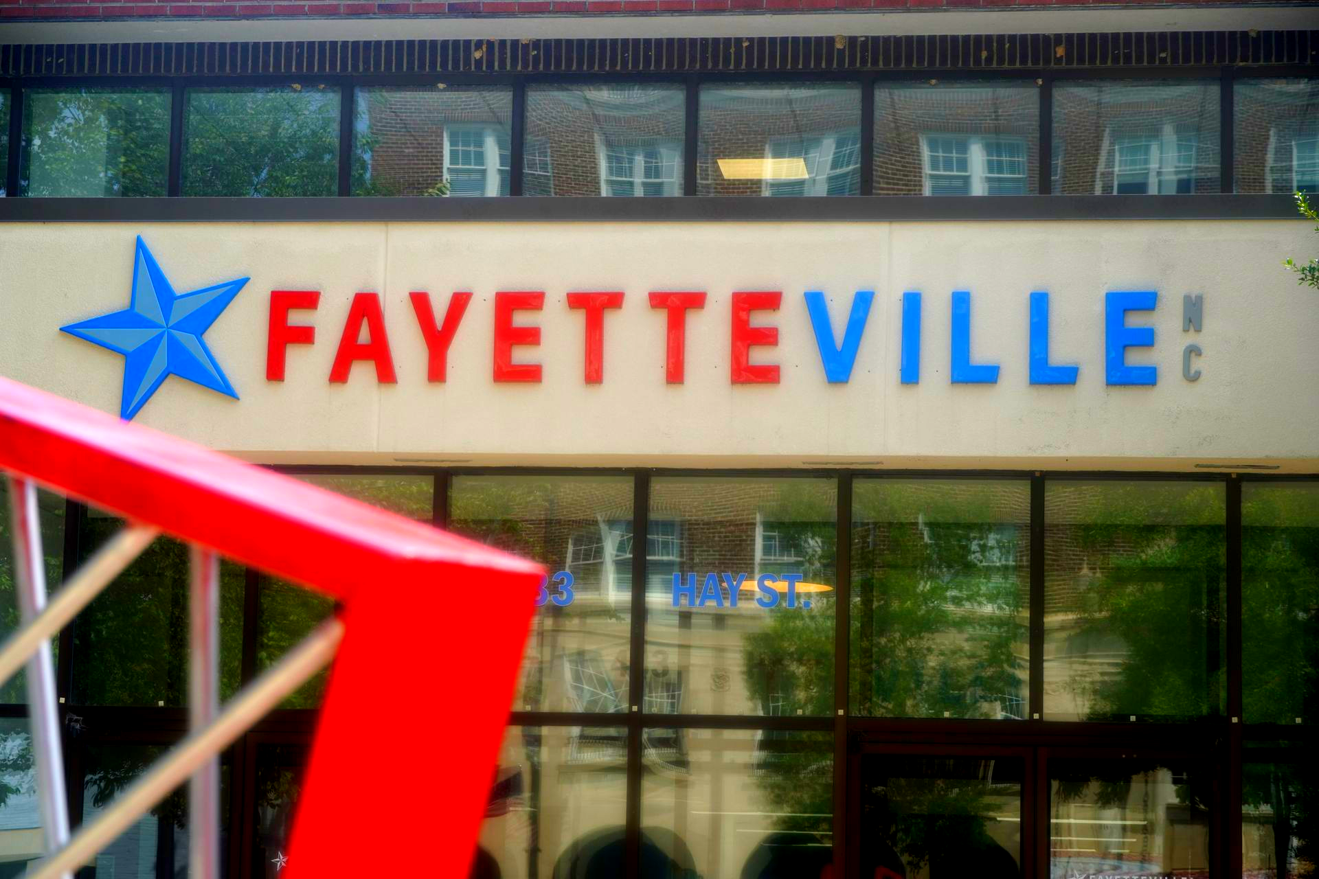 Fayetteville NC city landmark sign on Hay Street downtown | Local welcome sign near Arts Council and Segra Stadium | Featured by Realtor Alexander Carrasco | AgentNow.RealEstate