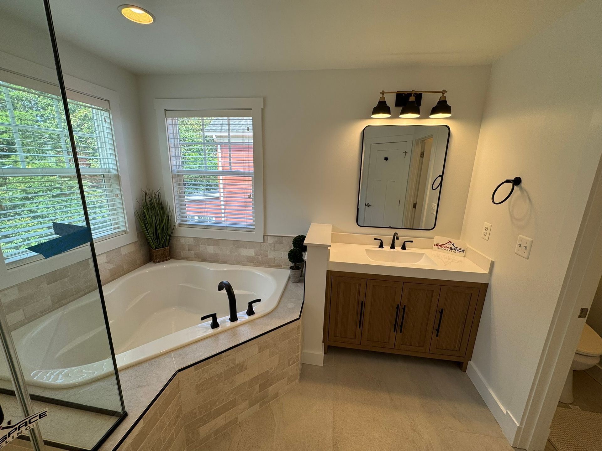 Bathroom renovation in Towson, MD featuring single vanity and wall-mounted mirror