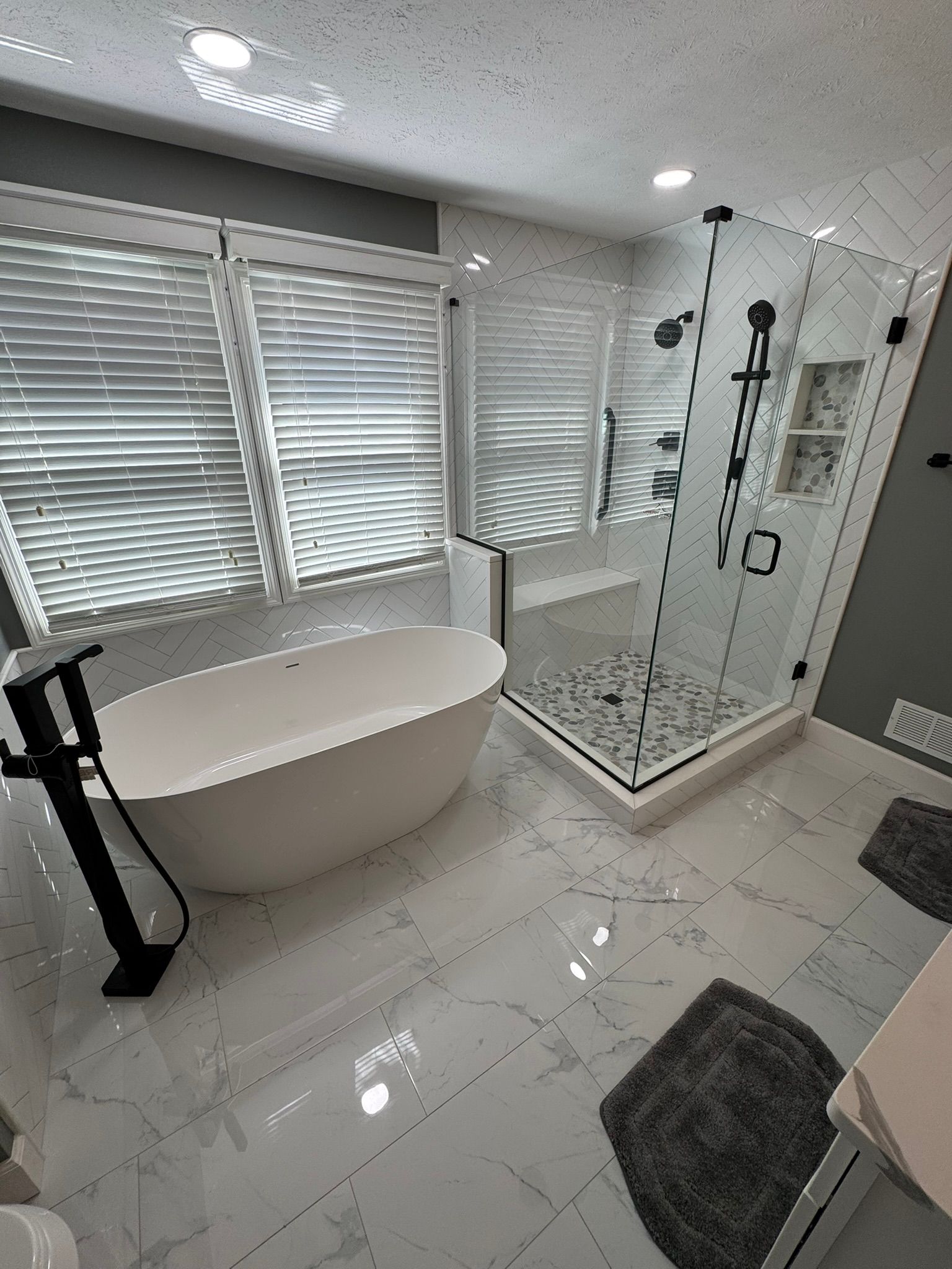 Modern spa-like bathroom with oversized shower and freestanding soaking tub