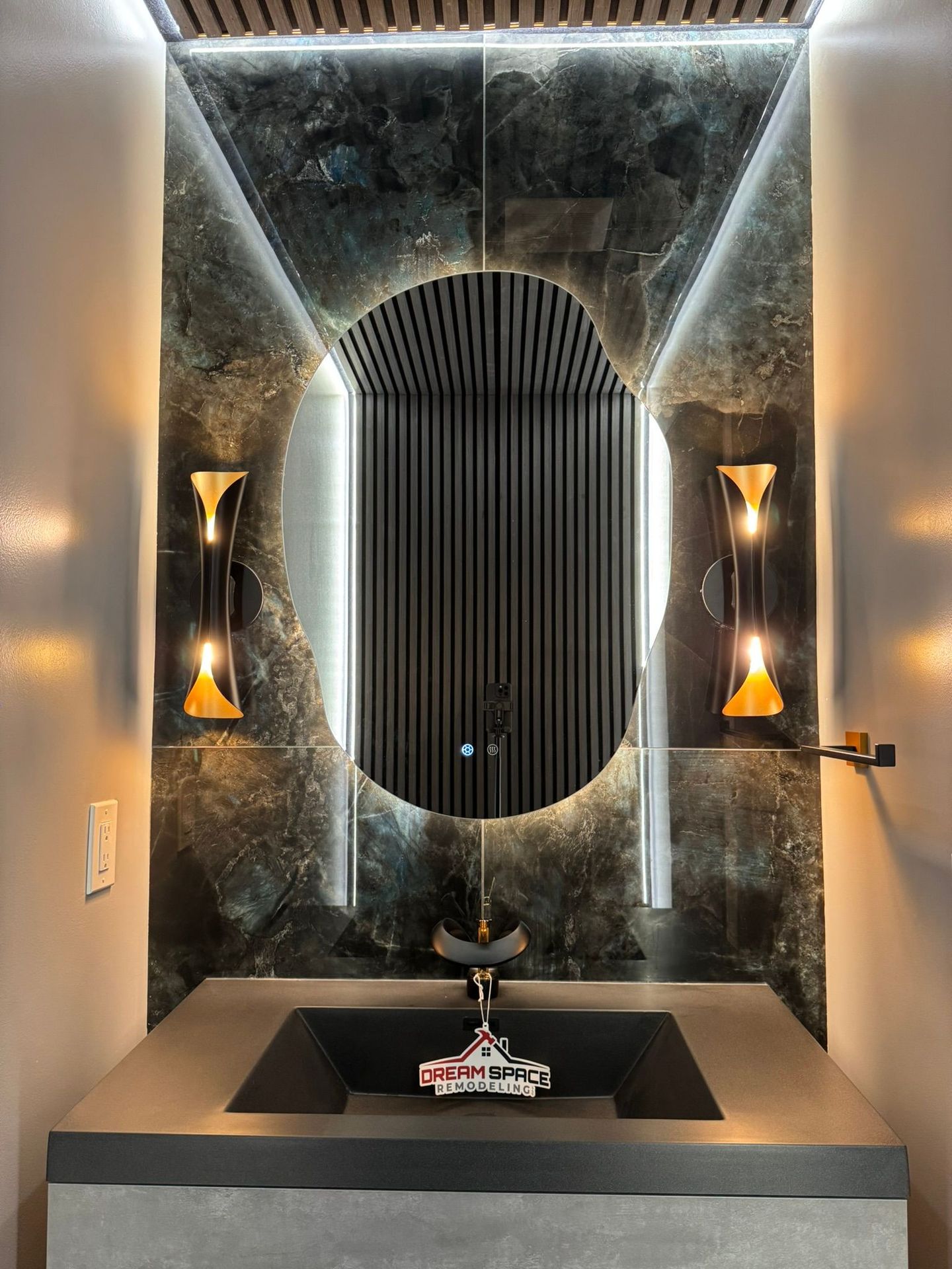 Bathroom remodeling Reisterstown, MD with modern powder room design featuring smart toilet, floating vanity, and black & gold faucet with LED lighting