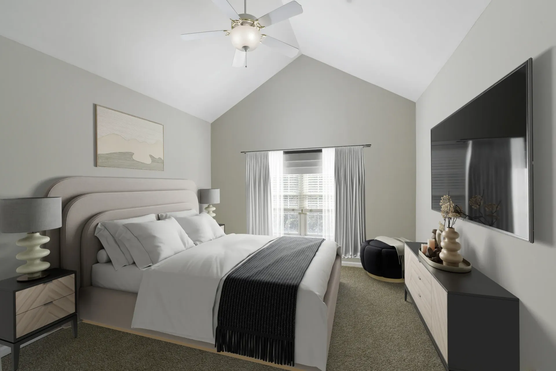 Bedroom in a modern apartment with a large bed, two nightstands, a dresser, and a wall-mounted TV at Springhouse Townhomes in Allentown, PA.
