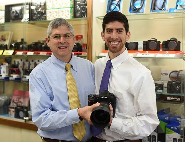 salesman holding camera