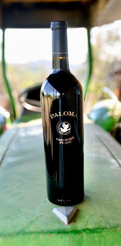 A bottle of palom wine is sitting on a table