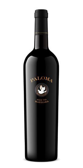 A bottle of paloma wine with a bird on the label