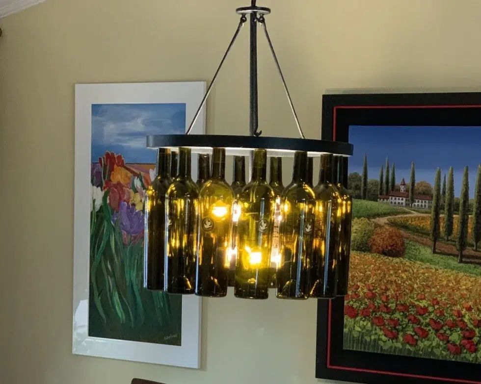 A chandelier made out of wine bottles hanging from the ceiling