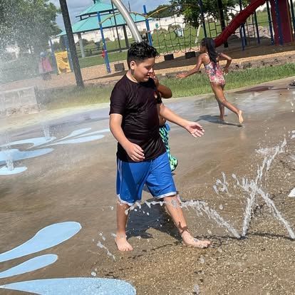 A boy and a girl are playing in a water park.