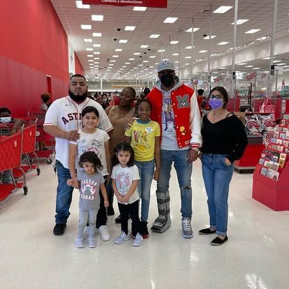 A group of people are posing for a picture in a store.
