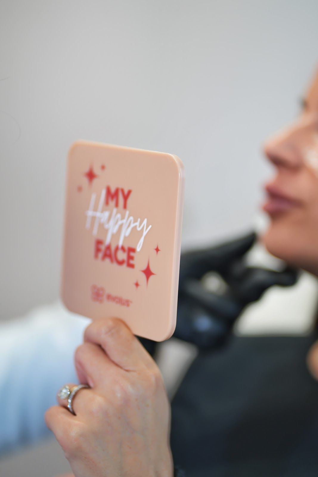 A woman holding a mirror that says 